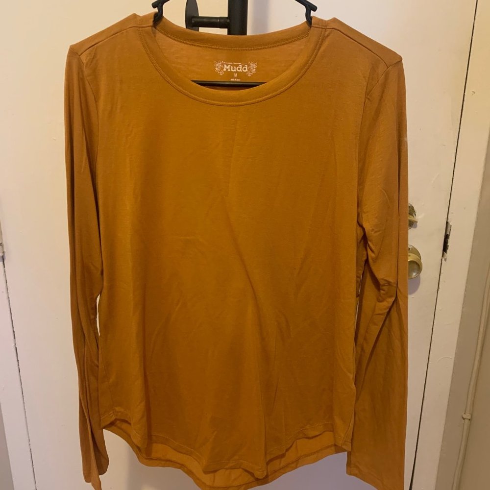 A gold long sleeve shirt